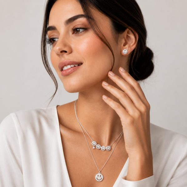 Juego cadena arete carita sonriente plateado