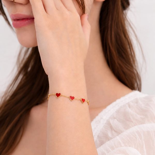 Pulsera corazones rojos dorada